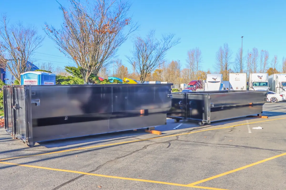 Professional dumpster rental service with roll-off container on residential driveway in Moses Lake